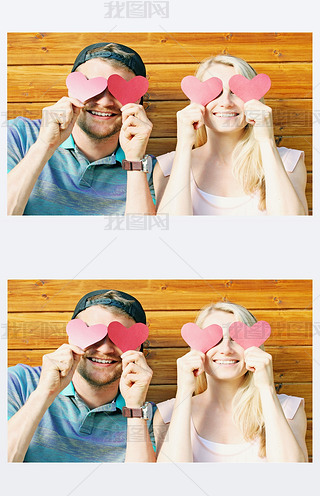 fall in love concept - young couple holding paper hearts over ey