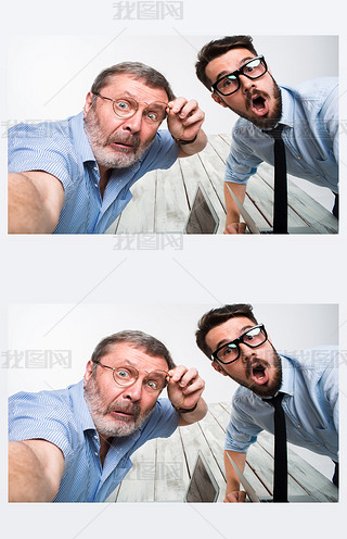 Two colleagues  taking the picture to them self sitting in office