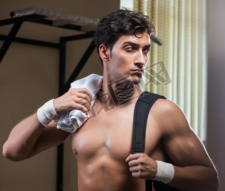 Man tired after workout in sports gym