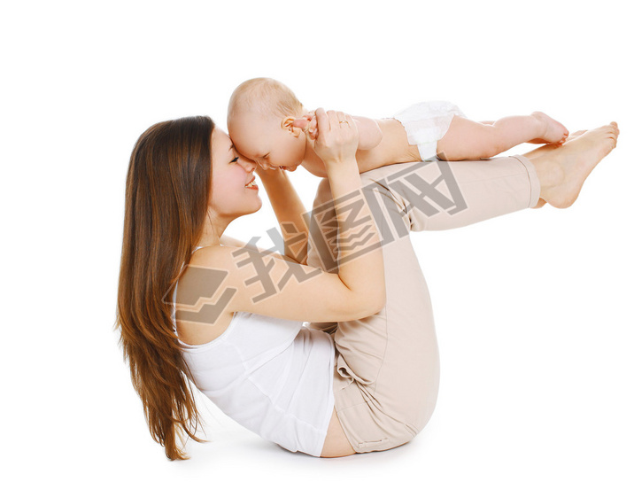 Young mother and baby are doing exercise and hing fun on a whi