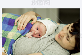 happy woman after birth with a newborn baby