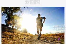 Silhouette of young sport man running off road cross country competition at summer sunset
