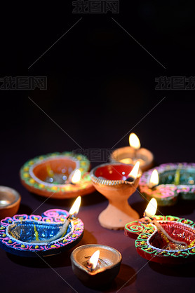 Colorful clay Diya (Lantern) lamps lit during Diwali celebration. Greetings Card Design Indian Hindu