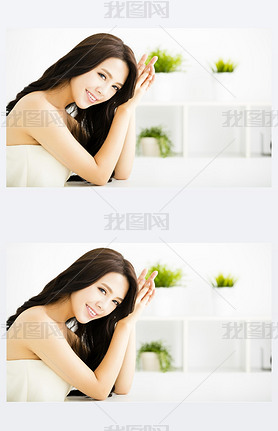 Smiling young beautiful woman sitting in living room