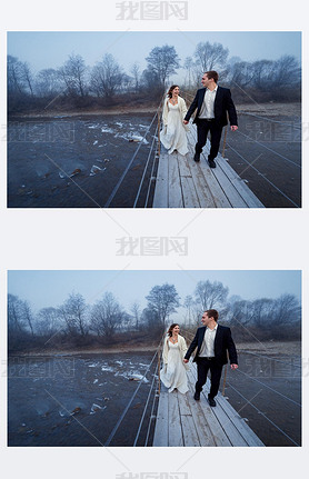 Happy wedding couple laughing and hing fun on the suspension bridge in mountains