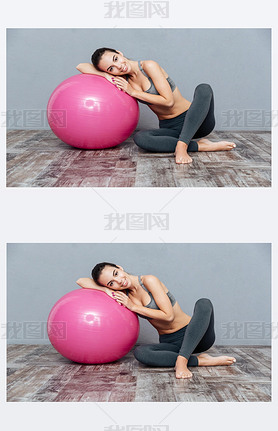 Young beautiful fitness girl with pink ball isolated on grey