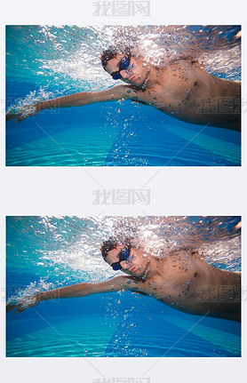 Young man swimming the front crawl in a pool - underwater shot (