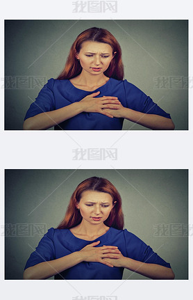 young woman with breast pain touching chest isolated on gray wall background