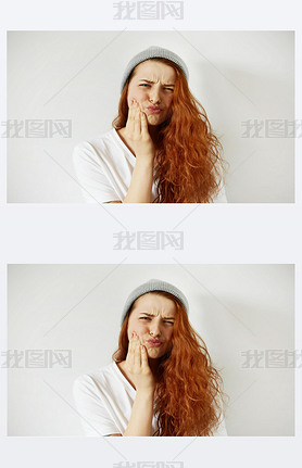 woman pressing cheek with painful expressio