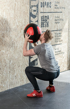 Man training with exercise ball
