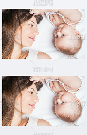 Happy mother with a baby lying on a white bed