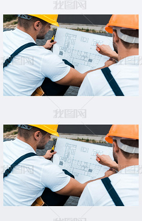 selective focus of builders in helmets looking at blueprint 