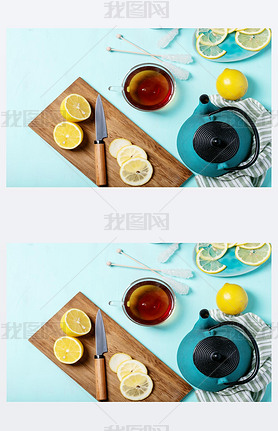 Black tea in glass cup served with fresh lemons over a cyan texture background. Top view. Copy Space