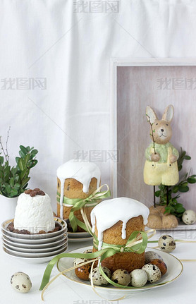 Easter still life with Easter cake kulich, paskha and painted eggs on a light background.