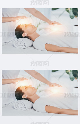 cropped shot of reiki healer doing therapy session to calm young woman with closed eyes