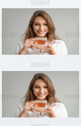 Beautiful young woman with cup of tea on grey background