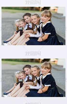 Schoolgirls in school uniform rest on a break near the school