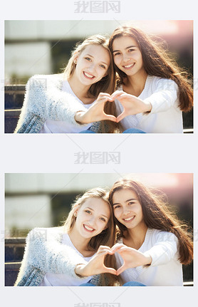 Two Teenagers Holding Hands in Shape of Heart