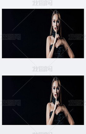 panoramic shot of scary vampire girl in black gothic dress showing shh sign isolated on black