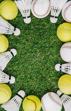 top view of arrangement of badminton shuttlecocks, tennis and baseball balls on green lawn