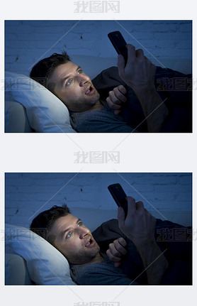 man in bed couch at home late at night using mobile phone in low light watching online porn