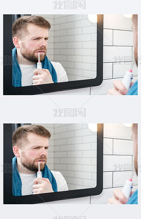 Serious man brushing his teeth with an electric oral irrigator with a jet of water, looking in the m