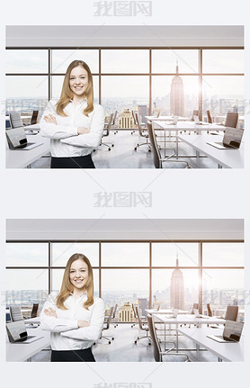 Smiling beautiful business lady with cross hands is standing in a modern panoramic office in New Yor