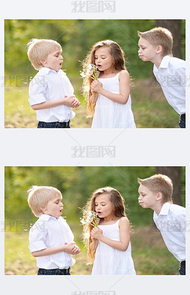 three children playing on meadow in summer