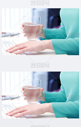 Woman holding in her hand a glass of water