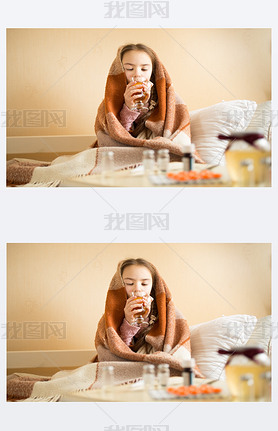 Portrait of sick girl covered in blanket drinking hot tea