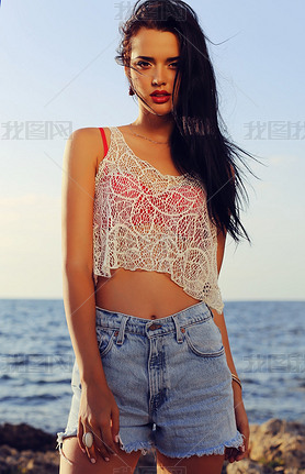 y woman with dark hair  on the beach