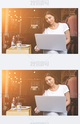 Young female student using laptop computer for learning while sitting in cafe 