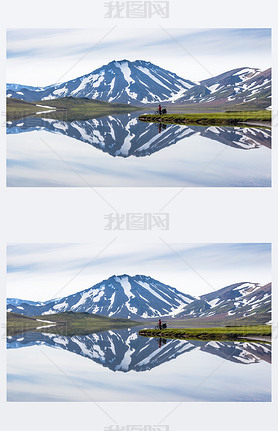 biker on backdrop of lake and mountains