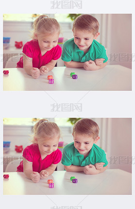 Two happy children playing with dices