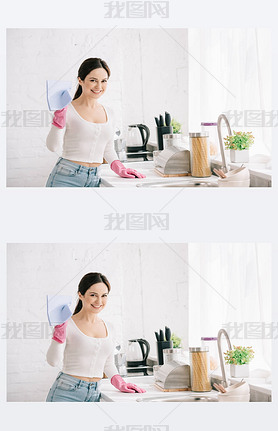 happy housewife looking at camera while standing in kitchen and holding rag