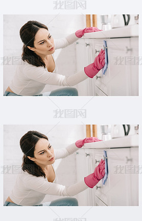 attractive housewife washing kitchen furniture with rag