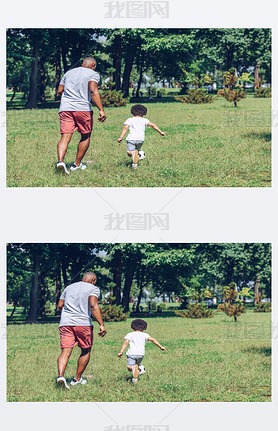 back view of african american father and son playing football in park