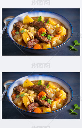 Beef meat stewed with potatoes, carrots and spices in bowl on dark gray background.  horizontal imag