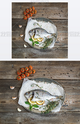 Roasted dorado or sea bream fish with vegetables, herbs and spices on silver tray over rustic wood b