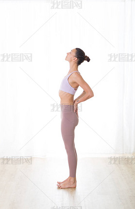 Portrait of gorgeous active sporty young woman practicing yoga in studio. Beautiful girl practice Ar