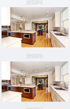 White interior of kitchen room with large kitchen island.