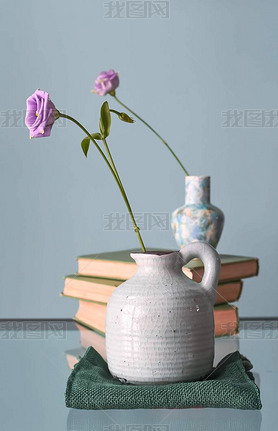 Retro home decor: a stack of books, flower in a vase