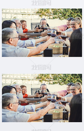 Happy family cheering with red wine at reunion dinner in garden - Senior hing fun toasting winegla