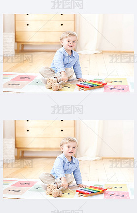 The boy plays xylophone at home. Cute iling positive boy playing with a toy musical instrument xyl