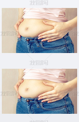 A young woman in jeans and a light T-shirt is standing sideways and holding her hands squeezes belly