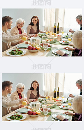 Young man pouring orange juice for his granny during family dinner by served festive table on Thanks