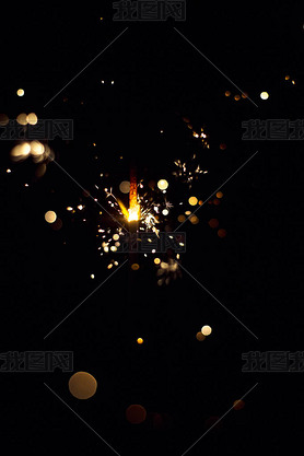 Glowing flow of sparkler, bokeh shine in the dark background