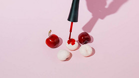 Painting cherries on a pink background. Minimal concept with a shadow.
