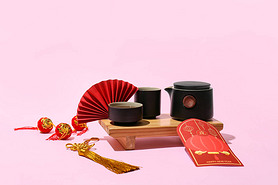 Red envelope with tea and Chinese symbols on color background. New Year celebration