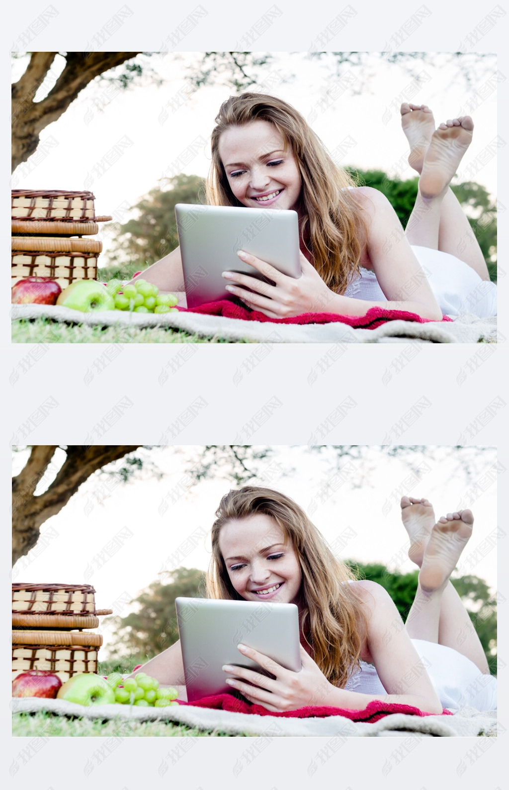 woman reads tablet lying on grass